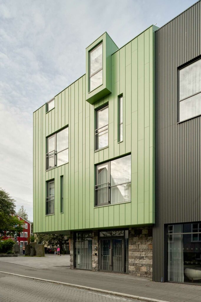 Green and black metal cladding building in Reykjavik, Iceland