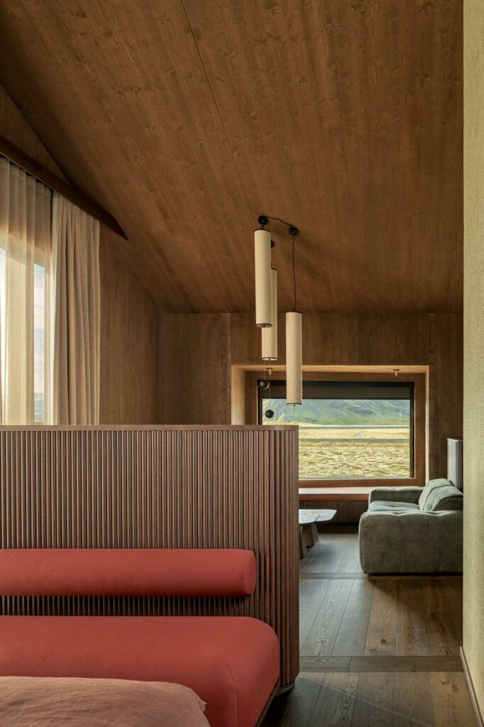 Luxury hotel suite with red couch and wooden ceiling