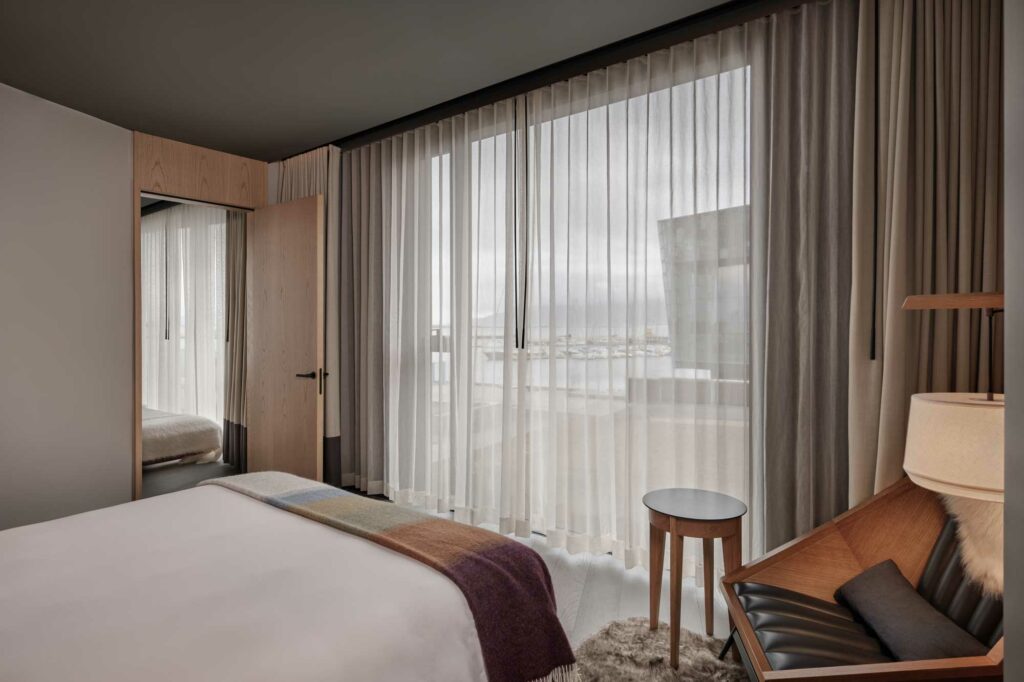 Hotel room with large windows overlooking the street